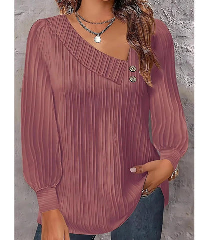 Blusa feminina plissada com botões no ombro, design elegante, mangas bufantes e decote assimétrico, ideal para looks sofisticados. Blusa feminina plissada com botões no ombro, design elegante, mangas bufantes e decote assimétrico, ideal para looks sofisticados.