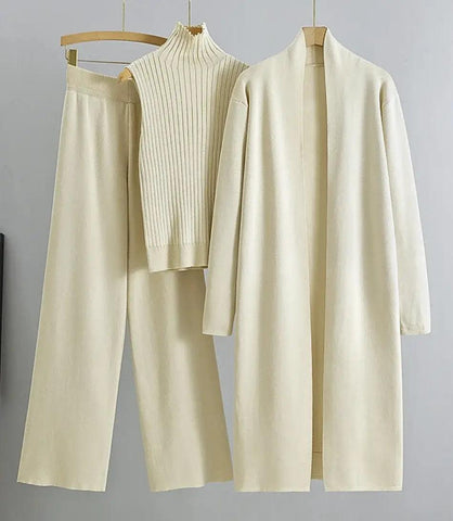 Mulher vestindo Conjunto Comfy Feminino de Lanzinha 3 peças com casaco longo, colete de gola alta e calça de cintura alta, ideal para outono e primavera. - Anellimn Mulher vestindo Conjunto Comfy Feminino de Lanzinha 3 peças com casaco longo, colete de gola alta e calça de cintura alta, ideal para outono e primavera. - Anellimn