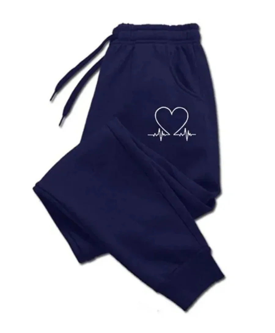 Calça de moletom feminina básica em poliéster respirável, com corte cônico, bolsos com zíper e cós ajustável. Conforto e estilo para todas as ocasiões.