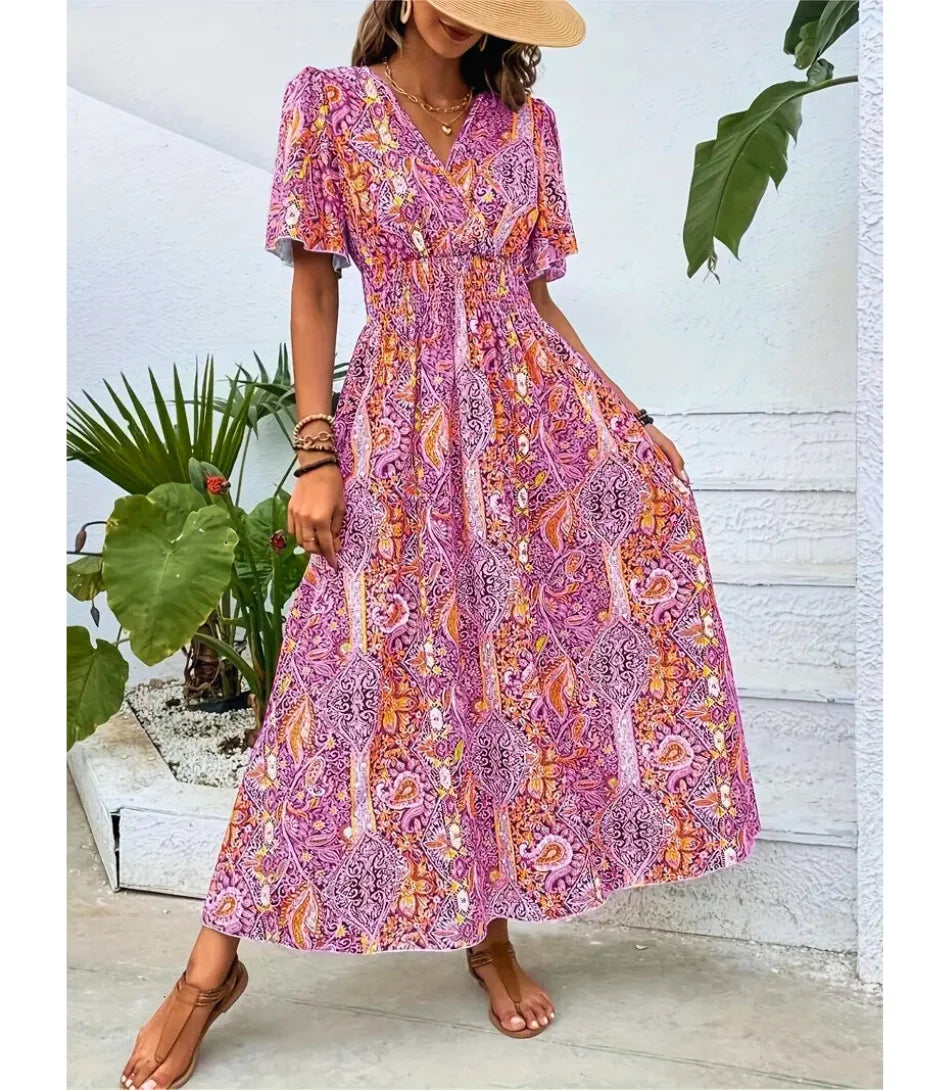 Vestido Boho Chic Longo estampado, com decote em V, mangas amplas e cintura ajustável, perfeito para ocasiões casuais e elegantes.