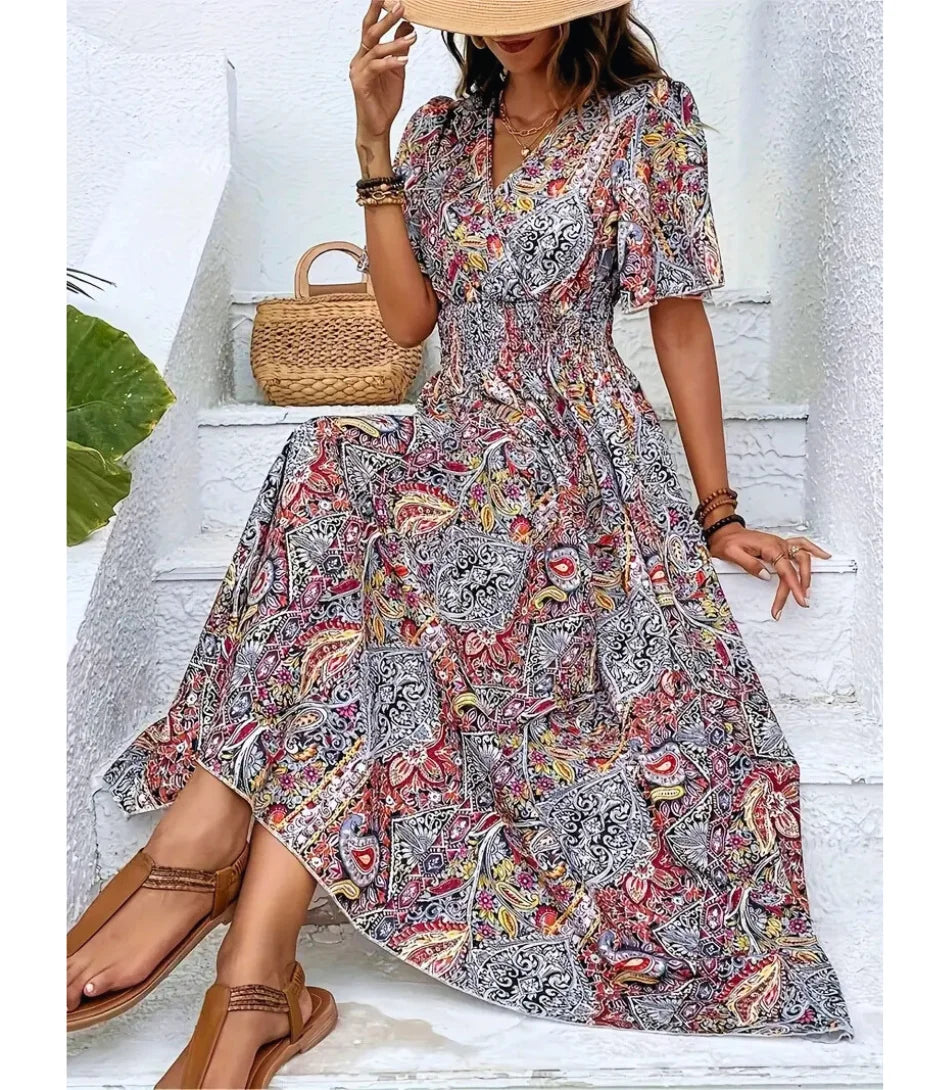 Vestido Boho Chic Longo estampado, com decote em V, mangas amplas e cintura ajustável, perfeito para ocasiões casuais e elegantes.