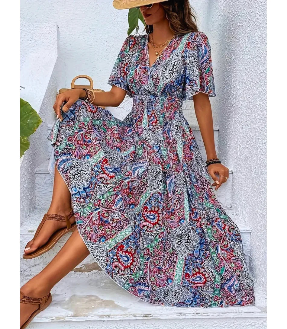 Vestido Boho Chic Longo estampado, com decote em V, mangas amplas e cintura ajustável, perfeito para ocasiões casuais e elegantes.