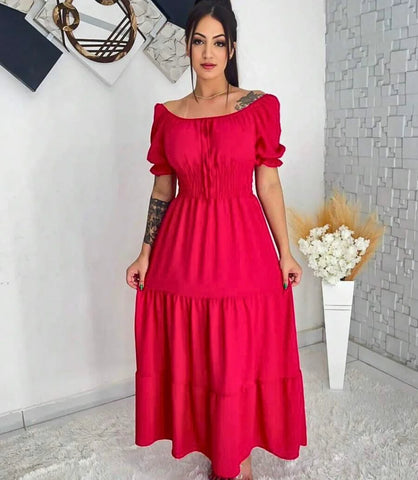 Vestido longo boho feminino com babados, confeccionado em viscose sustentável, com cintura ajustável e design fluido ideal para eventos e dias casuais.