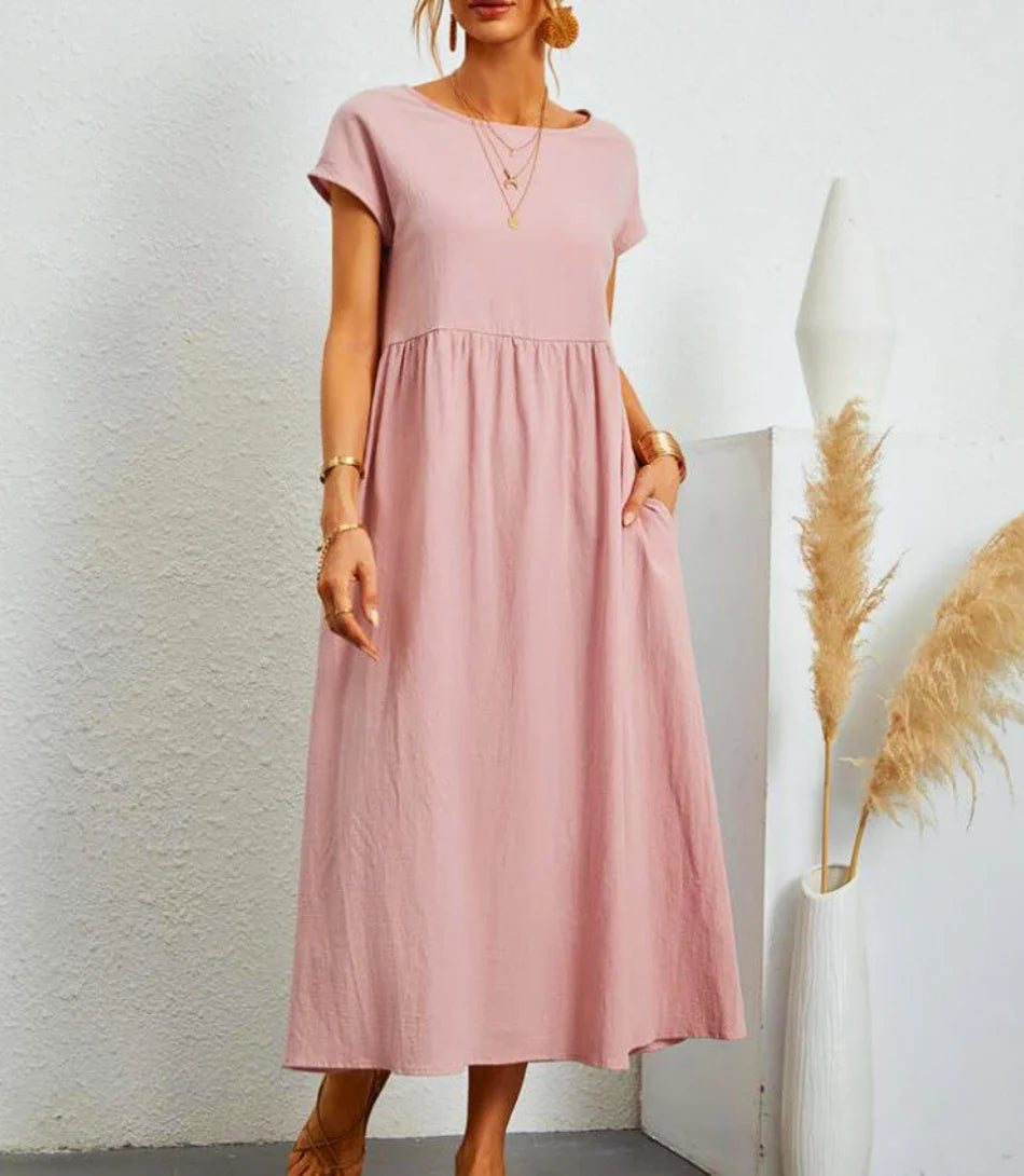 Vestido longo feminino casual em algodão e linho com bolsos laterais e mangas curtas para estilo e conforto.