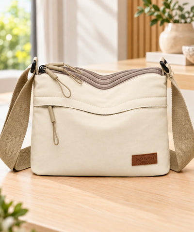 Bolsa transversal feminina pequena off white vista de frente