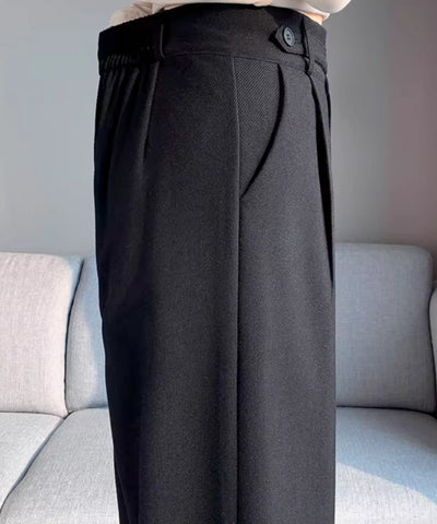 Detalhe do cós traseiro com elástico e botão lateral da calça wide leg alfaiataria preta