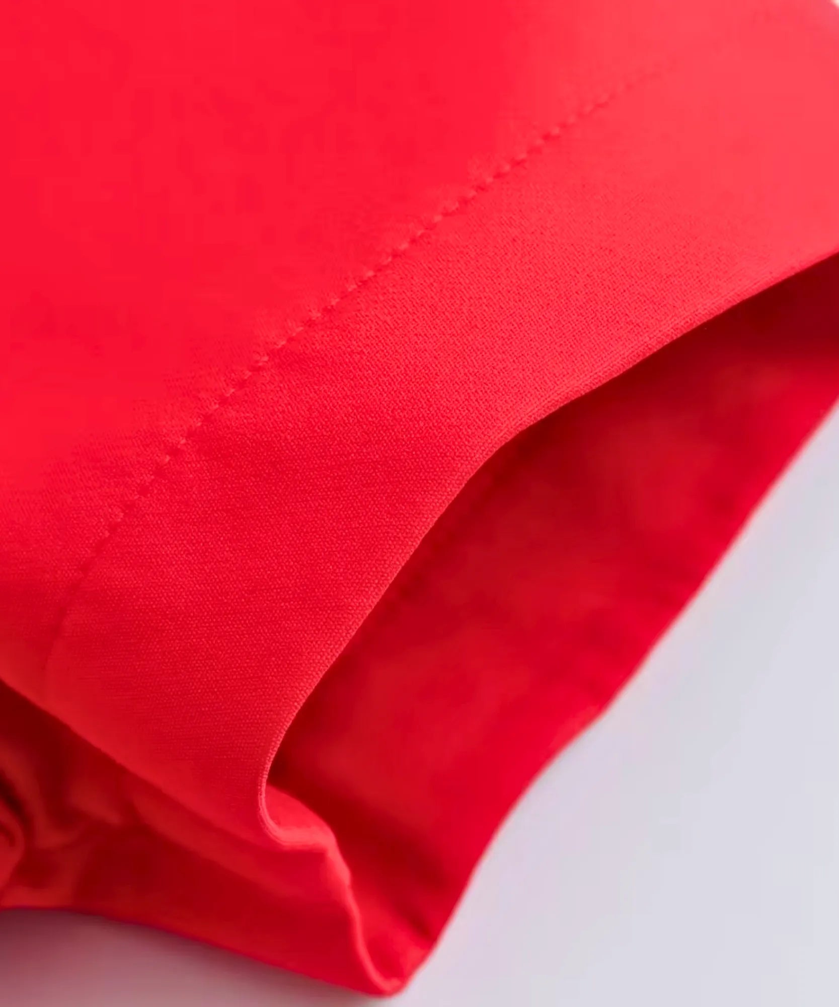 Textura do tecido alfaiataria vermelho do macaquinho feminino