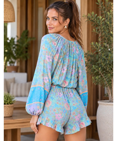 Macaquinho feminino manga longa azul estampado, vista de costas, corpo inteiro