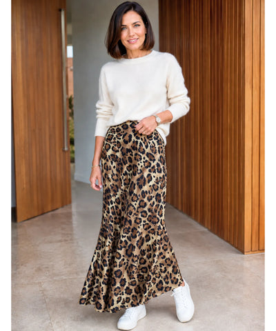 Saia longa animal print caramelo combinada com tricô branco e tênis